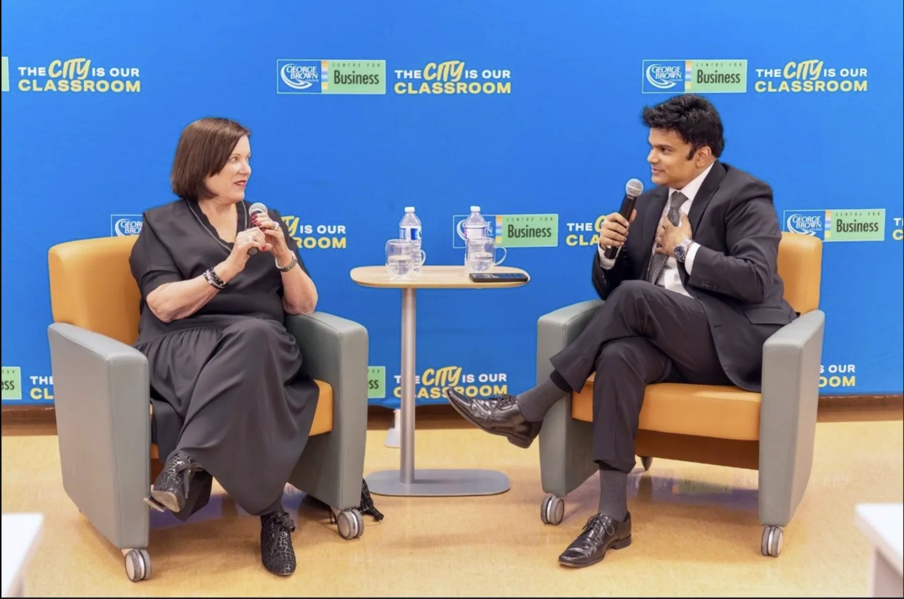 Aakash Andrews in conversation onstage at an education event