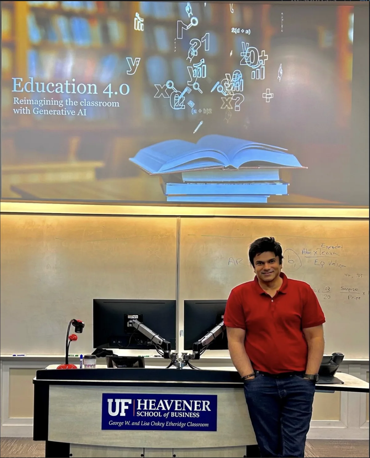 Aakash Andrews in a UF Heavener classroom beneath an Education 4.0 presentation