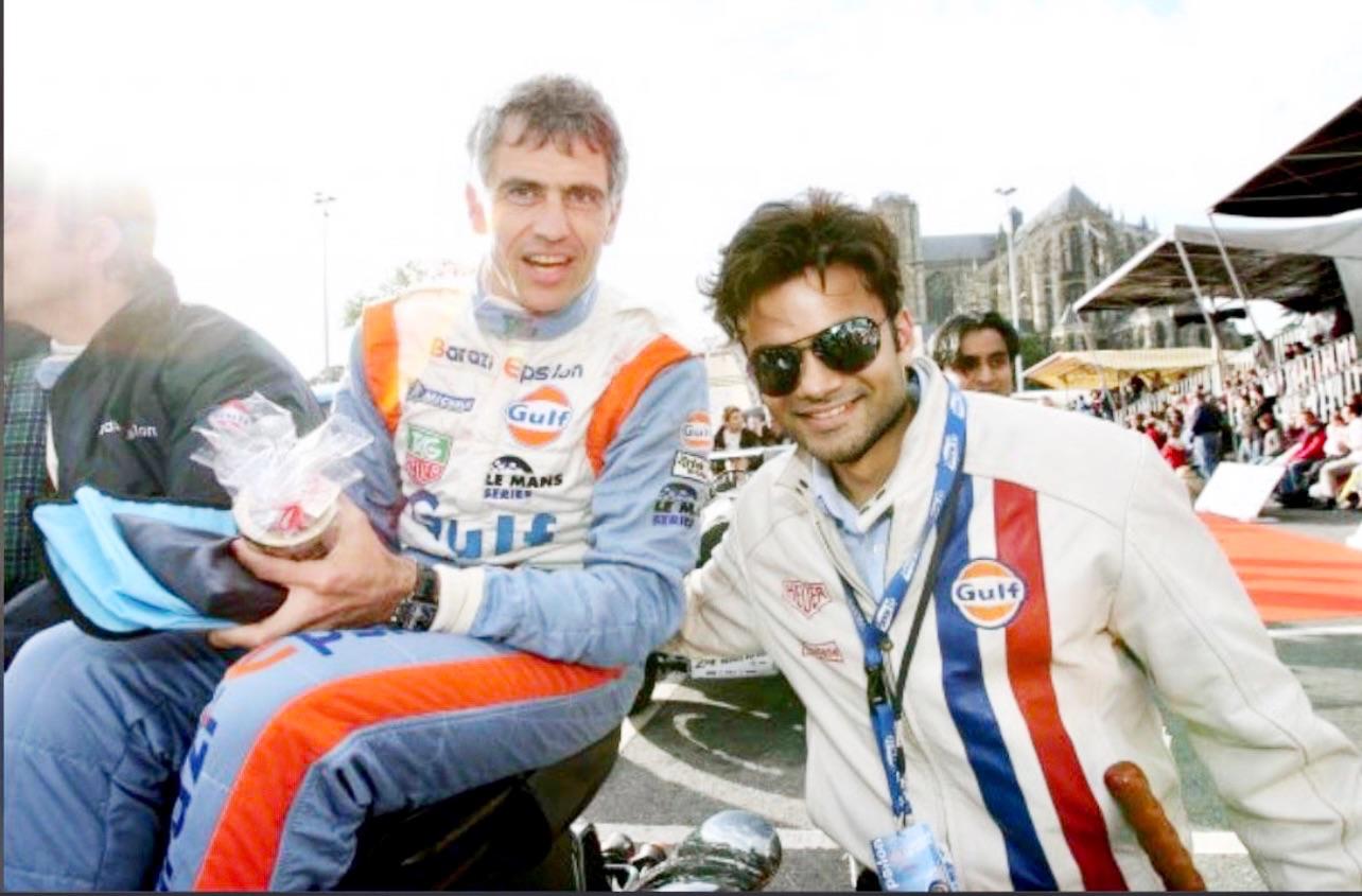 Aakash Andrews with a racing driver at a motorsport event