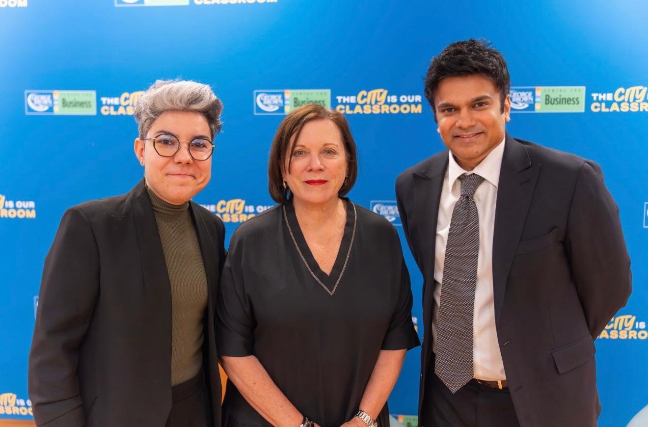 Aakash Andrews with two attendees at an event