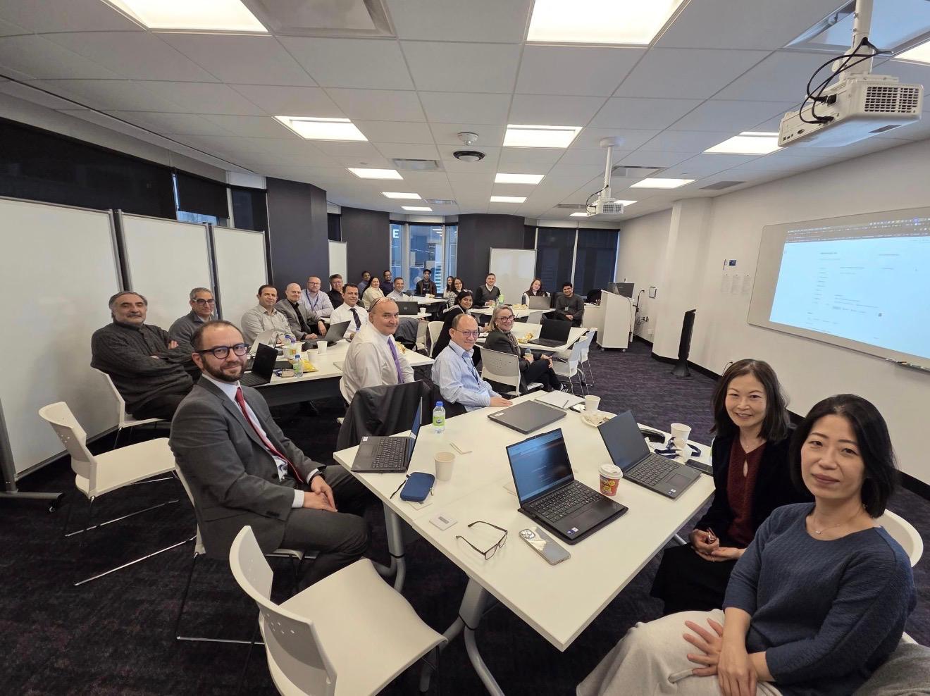 Participants seated around tables during a collaborative learning session